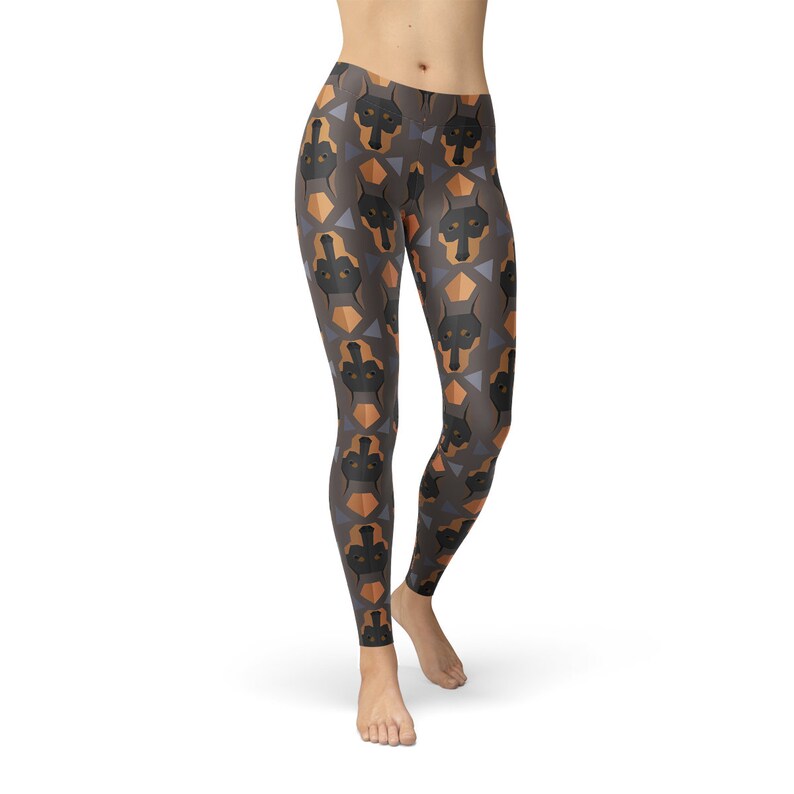 May include: Black leggings with a geometric pattern featuring brown and tan Doberman Pinscher dog faces.