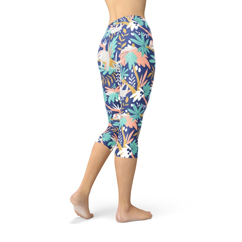 May include: Blue capri leggings with a colorful print of sloths and tropical plants.