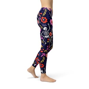 May include: Black leggings with a colorful floral and skeleton print. The print features pink, orange, yellow, and white flowers and skeletons.