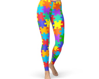 May include: Vibrant leggings featuring a colorful jigsaw puzzle pattern. The leggings display a variety of bright colors, including red, orange, yellow, green, blue, and purple. The design covers the entire garment, creating a bold and eye-catching look.