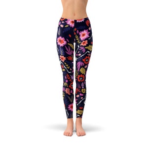 May include: Black leggings with a floral and skeleton print. The flowers are pink, red, orange, and yellow. The skeletons are white.