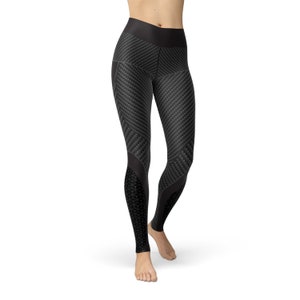 May include: Black leggings with a carbon fiber pattern. The leggings have a geometric design on the sides.