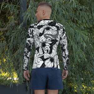 May include: A black and white long-sleeve shirt with a graphic print of koi fish and flowers. The shirt has a crew neck and a fitted silhouette.