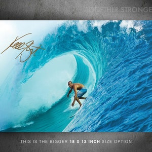 May include: A surfer rides a large, blue wave. The wave is breaking and creating a barrel. The surfer is wearing a black wetsuit and a blue board short. The text "Together Stronger" is visible in the upper right corner of the image.