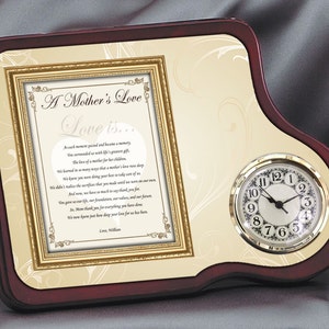 May include: A mahogany-colored wooden plaque with a gold-framed picture of a poem about a mother's love. The plaque also features a small clock with a white face and black hands.