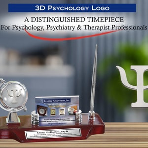 May include: A silver desk set with a globe featuring the psychology symbol, a pen holder, and a business card holder. The desk set is on a wooden base with a personalized plaque that reads "Cindy McDaniels, PsyD".