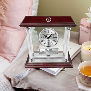 May include: A silver desk clock with a Roman numeral face and a mahogany base. The clock is engraved with the text "Tim J. Walker Enjoy the gift of time We are so incredibly thankful for your 10 years of service at Alliance Engineering Corp Engraved Desk Clocks by AllGiftPresents.com".