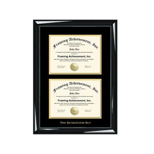May include: A black frame with a gold mat and two diplomas inside. The diplomas are for Framing Achievement, Inc. and are both signed by John Doe.
