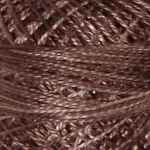 May include: A close-up of a spool of brown embroidery floss.