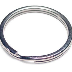 May include: A silver key ring with a split ring opening.