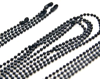 May include: A black metal chain with round links. The chain is made of small, evenly spaced beads.