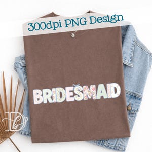 May include: A brown t-shirt with the word "BRIDESMAID" in a floral and pastel design. The text "300dpi PNG Design" is printed across the top. A denim jacket is visible in the background.