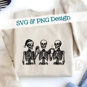 May include: Beige sweatshirt with a black and white graphic of three skeletons. One skeleton wears a Santa hat, another holds an ornament, and the third holds a coffee mug. The text "SVG & PNG Design" is across the top.