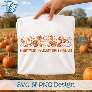 May include: A white t-shirt featuring a burnt orange graphic design of pumpkins, sunflowers, leaves, and acorns. The text "PUMPKIN SEASON HALLELUJAH" is printed in a bold, sans-serif font below the botanical illustration on the front of the shirt.