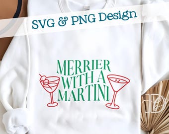 May include: White sweatshirt featuring the text "Merrier With A Martini" in green and red, with two martini glass illustrations. The words "SVG & PNG Design" are written across the top.
