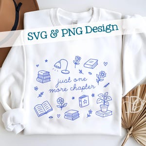 May include: White sweatshirt with a blue line art design featuring books, flowers, a lamp, and the text "just one more chapter". The words "SVG & PNG Design" are also printed on the sweatshirt.