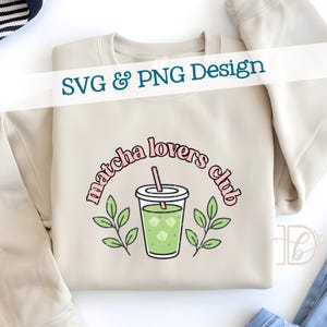 May include: Beige sweatshirt with a graphic design that reads "matcha lovers club" in pink lettering. The design includes a green matcha drink with ice cubes, a pink straw, and green leaves. The text "SVG & PNG Design" is also present.
