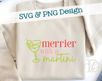 May include: A cream-coloured sweatshirt featuring the phrase "merrier with a martini" in pink and green, alongside a lime green martini glass graphic. The words "SVG & PNG Design" are written across the top.