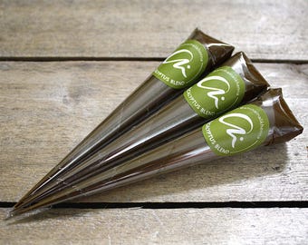 May include: Three brown henna cones with green labels that say "ammirah henna" and "eucalyptus blend".