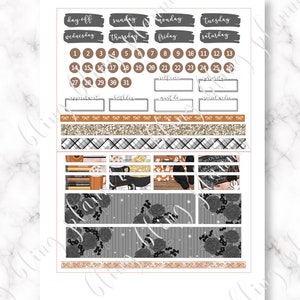 May include: A set of Halloween-themed planner stickers featuring a black and white floral pattern, a chalkboard with the words "Boo!" and "Trick or Treat", a witch's hat, a cauldron, and a stack of books. The stickers are on a white background with a gold glitter pattern.