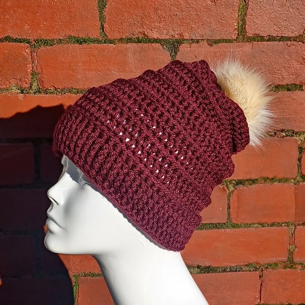 Crochet burgundy winter hat with beige fur pompom, dark red slouchy beanie