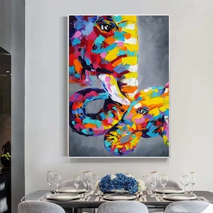 May include: A colourful abstract painting of two elephants, one large and one small, with a grey background. The elephants are painted in a variety of bright colours, including pink, yellow, blue, and green.