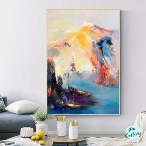 May include: Abstract painting with a colorful landscape of mountains and clouds in shades of blue, yellow, pink, and red. The painting has a textured, brushstroke effect.