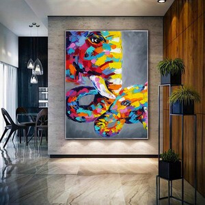 May include: Abstract painting of two elephants, one large and one small, in a colourful, expressive style. The elephants are painted in shades of pink, yellow, blue, green, and orange.