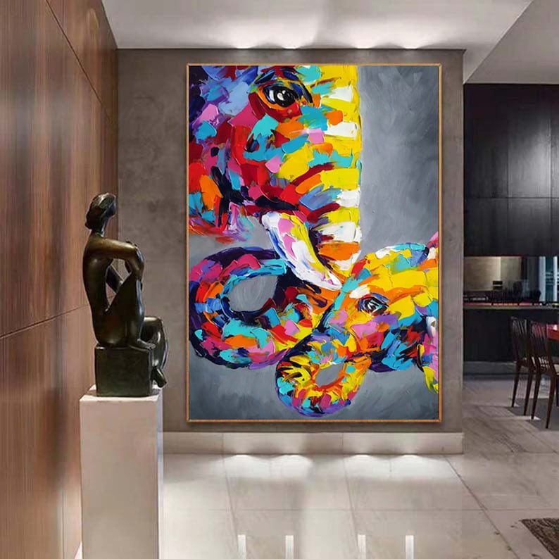May include: Abstract painting of two elephants, one large and one small, with colourful, textured brushstrokes. The elephants are painted in shades of pink, yellow, blue, green, and orange against a grey background.