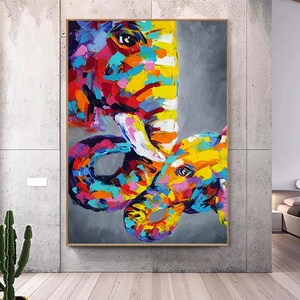 May include: A colourful abstract painting of two elephants, one large and one small, with their trunks intertwined. The painting is done in a vibrant palette of blues, greens, yellows, pinks and reds.