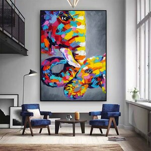 May include: Abstract painting of two elephants, one large and one small, in a colourful, vibrant style. The elephants are painted in shades of pink, yellow, blue, green, and purple. The background is a muted grey.