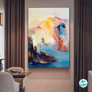 May include: Abstract painting of a colorful mountain landscape with shades of blue, yellow, pink, and red. The painting has a textured, brushstroke effect.