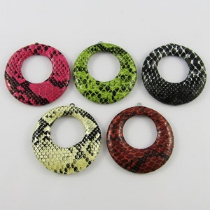 May include: Five round, decorative, snake skin patterned, leather rings in different colours: pink, green, black, yellow, and red.