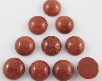 May include: Ten round, brown sandstone cabochons, each with a smooth, polished surface. The cabochons are arranged in a triangular pattern on a white background.