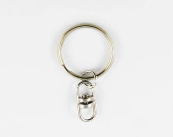 May include: Silver key ring with a swivel clasp. The key ring is attached to a silver swivel hook.