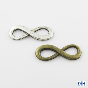 May include: Two infinity symbol charms, one silver and one antique bronze.