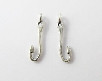 May include: Two silver-toned fish hook charms with a loop at the top for attaching to jewelry or other crafts.