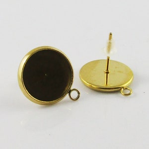 May include: Gold-toned metal earring blanks with a round bezel setting and a loop for attaching a charm or pendant. The earring posts are also gold-toned.