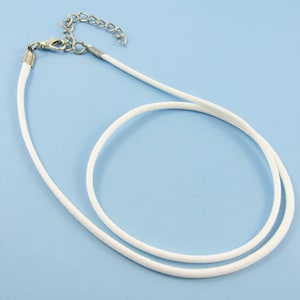 May include: White cord necklace with a silver clasp and chain.