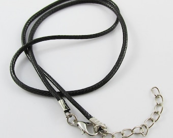 May include: A black cord necklace with a silver clasp and extender chain.