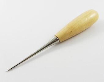 May include: A wooden-handled awl with a metal needle. The awl is used for piercing holes in leather or other materials.