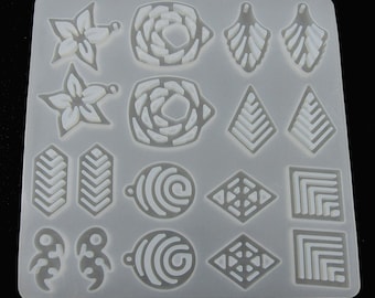May include: A silicone mold for making earrings. The mold has 16 different designs, including flowers, geometric shapes, and swirls. The mold is white and has a smooth surface.