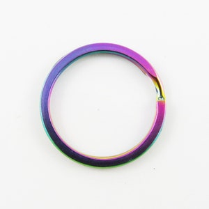 May include: A rainbow-colored metal key ring. The ring is made of a durable metal and has a smooth finish.