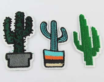 May include: Three embroidered cactus patches. One cactus is green with a grey pot, one is teal with an orange and black striped pot, and one is green with no pot.
