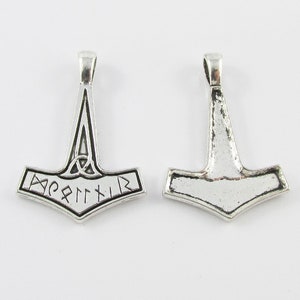 May include: Silver pendant in the shape of Thor's hammer, Mjolnir, with a knotwork design and the inscription "Mjolnir" in runes.