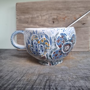 A large mug decorated with blue stylized flowers - A Handcrafted Gift for Daily Comfort