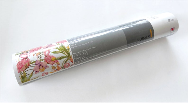 May include: A rolled up wallpaper mural with a pink flamingo and floral pattern. The label reads "MURAL'S" and includes the text "This mural is not considered to be repeat."