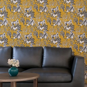 May include: A black leather sofa with a yellow and white wallpaper featuring a repeating pattern of monkeys and tropical leaves.