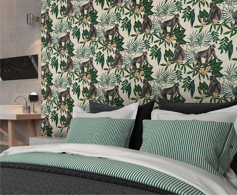 May include: A white and green wallpaper with a repeating pattern of monkeys and tropical leaves. The monkeys are brown and sitting on branches. The leaves are green and have a variety of shapes.