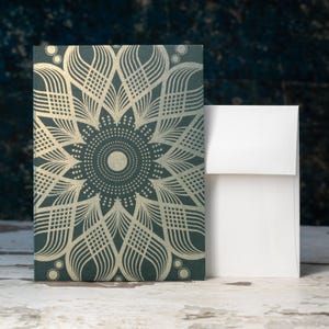 May include: A green card with a gold mandala design. The card has a white envelope.